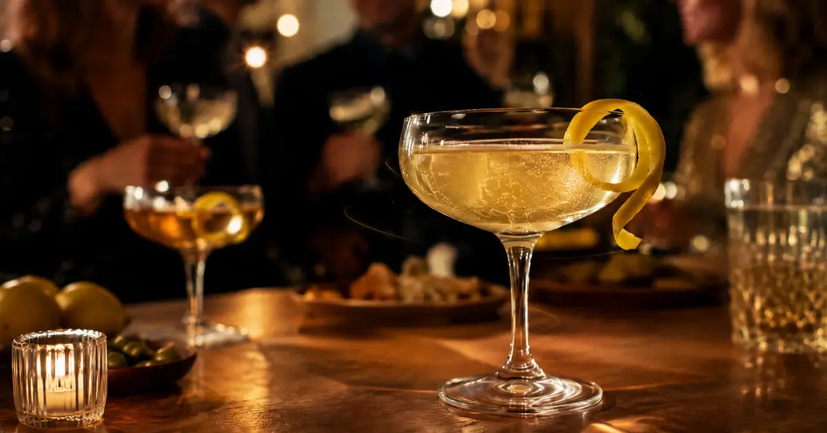 Sparkling New Year's Eve cocktail with lemon twist at a warm home celebration